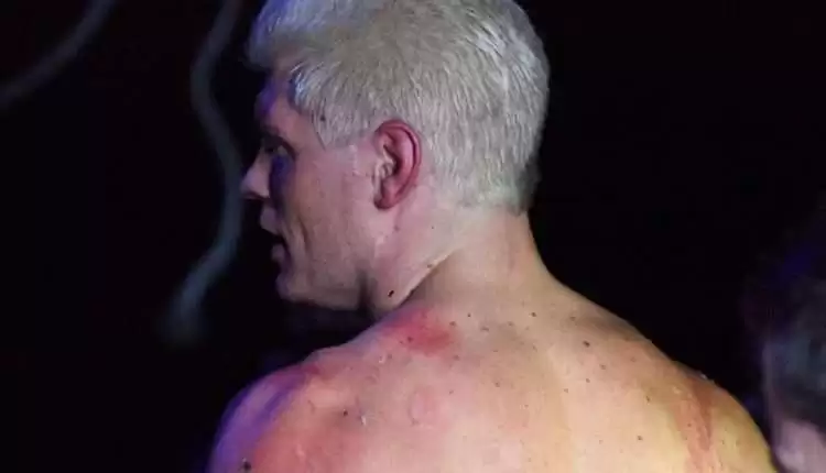 Cody Rhodes suplexes Andrade El Idolo through a flaming table; Photos of Cody's back